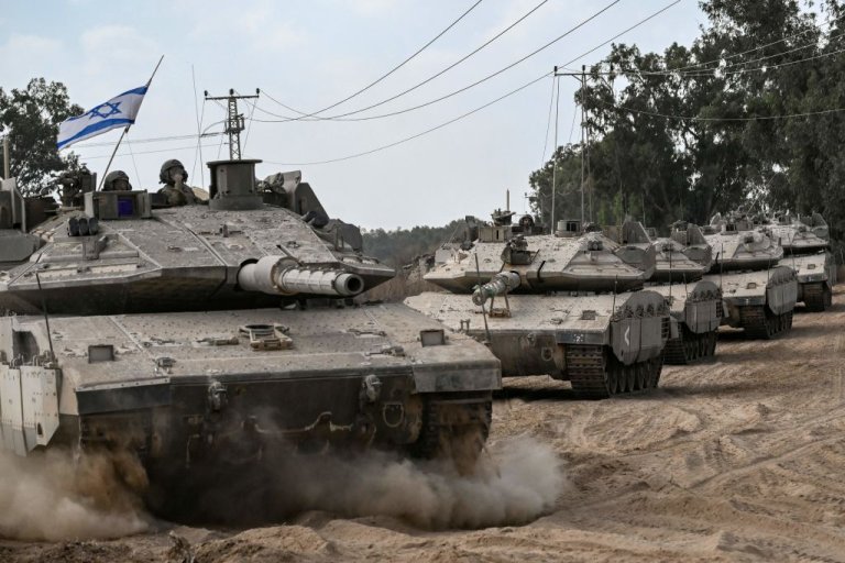 Israeli army Merkava battle tanks deploy along the border with the Gaza Strip.